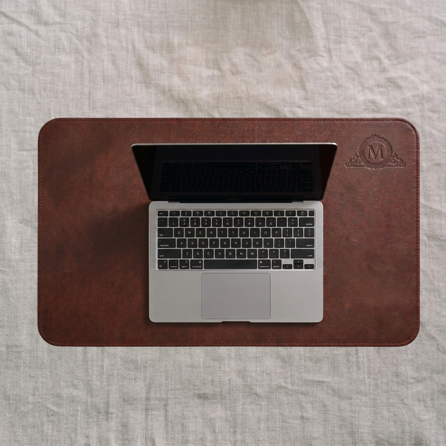 Dark burgundy leather desk mat with embossed Mohr crest